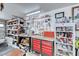 Well-organized garage workshop featuring shelving, cabinets and a pegboard for tool storage at 902 Little Raven St, Henderson, NV 89002