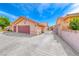 Spacious three-car garage with ample driveway space and secure gate for added privacy and convenience at 902 Little Raven St, Henderson, NV 89002