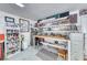 Organized garage workshop with ample lighting, storage, shelving, and workspace for projects at 902 Little Raven St, Henderson, NV 89002