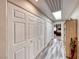 Hallway with ample storage, featuring multiple closets and a skylight for natural light at 902 Little Raven St, Henderson, NV 89002