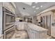 Gourmet kitchen with stainless steel appliances, granite counters, and ample cabinet space at 902 Little Raven St, Henderson, NV 89002