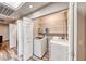 Compact laundry area with washer, dryer, folding doors and shelving for optimal organization at 902 Little Raven St, Henderson, NV 89002
