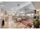 Open-concept living space featuring hardwood floors and a cozy fireplace with views of the kitchen and dining area at 902 Little Raven St, Henderson, NV 89002
