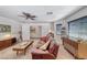 Cozy living room featuring a leather sofa, mid-century modern furniture, and natural light at 902 Little Raven St, Henderson, NV 89002