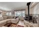 Inviting living room features a cozy fireplace and comfortable sectional sofa at 902 Little Raven St, Henderson, NV 89002
