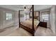 Bright main bedroom featuring a four-poster bed, neutral decor and access to the exterior at 902 Little Raven St, Henderson, NV 89002
