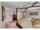 Spacious main bedroom with a four-poster bed frame, ceiling fan, and neutral decor at 902 Little Raven St, Henderson, NV 89002