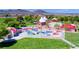 A colorful splash pad playground with fun water features, shades, and picnic spots at 902 Little Raven St, Henderson, NV 89002