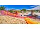 View of a large playground featuring slides, climbing structures, and shaded picnic areas at 902 Little Raven St, Henderson, NV 89002