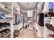 Spacious walk-in closet with custom shelving and storage for clothes, shoes, and accessories at 902 Little Raven St, Henderson, NV 89002