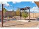 Backyard with minimal landscaping, a gravel pit, brick walls, some strung lights, and a partial overhang at 9091 Becket Ranch Ct, Las Vegas, NV 89113