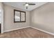 An empty bedroom with neutral walls, carpeted floors, a ceiling fan, and a window with brown shutters at 9091 Becket Ranch Ct, Las Vegas, NV 89113