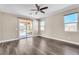 This bedroom offers a ceiling fan, natural light, wood-look floors, and sliding glass door to outdoor covered living at 9091 Becket Ranch Ct, Las Vegas, NV 89113