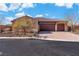 A beautiful home featuring a large three-car garage, landscaped front yard, and a classic Southwest design at 9091 Becket Ranch Ct, Las Vegas, NV 89113