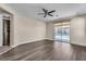 Spacious main bedroom featuring wood floors, ceiling fan and sliding glass doors to the backyard at 9091 Becket Ranch Ct, Las Vegas, NV 89113