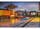 Backyard with stunning pool, spa and water feature illuminated by vibrant, colorful lighting at 9091 Becket Ranch Ct, Las Vegas, NV 89113