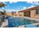 The backyard features a beautiful pool and spa, complemented by a covered patio and desert landscaping at 9091 Becket Ranch Ct, Las Vegas, NV 89113