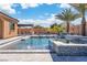 Sparkling pool features tiled spa, waterfall, and a covered outdoor dining area for ultimate relaxation and entertainment at 9091 Becket Ranch Ct, Las Vegas, NV 89113