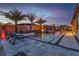 Stunning pool with waterfall feature, palm trees, and lounge chairs, perfect for outdoor relaxation and entertainment at 9091 Becket Ranch Ct, Las Vegas, NV 89113
