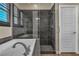 Close up of the glass enclosed shower with decorative tile and soaking tub in the main bathroom at 9091 Becket Ranch Ct, Las Vegas, NV 89113