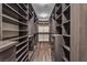 This walk-in closet features adjustable shelving and wood-look floors at 9091 Becket Ranch Ct, Las Vegas, NV 89113