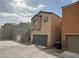 A row of houses with garage parking on a sunny street at 9145 Ebony Threads Ct, Las Vegas, NV 89149