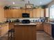 Charming kitchen featuring wooden cabinets, granite countertops, and a functional center island at 9145 Ebony Threads Ct, Las Vegas, NV 89149