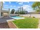 Spacious backyard with a refreshing pool, lush lawn, and mature trees under a sunny sky at 9916 Dusty Winds Ave, Las Vegas, NV 89117