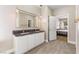 Elegant bathroom showcasing dual sinks, modern fixtures, and access to the Primary bedroom at 9916 Dusty Winds Ave, Las Vegas, NV 89117