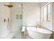 Chic bathroom featuring a glass shower, soaking tub, and upscale gold hardware at 9916 Dusty Winds Ave, Las Vegas, NV 89117