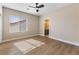 Bright bedroom boasts modern ceiling fan, wood-look floors, and ensuite bathroom access for added convenience at 9916 Dusty Winds Ave, Las Vegas, NV 89117