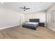 Spacious bedroom with wood floors, ceiling fan, recessed lighting, and large window at 9916 Dusty Winds Ave, Las Vegas, NV 89117