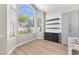 Breakfast nook with a large window, shelving, and light-colored walls at 9916 Dusty Winds Ave, Las Vegas, NV 89117