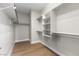 Walk-in closet with custom shelving and wood floors at 9916 Dusty Winds Ave, Las Vegas, NV 89117
