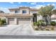 Inviting two-story home with a three-car garage, landscaped yard, and tile roof at 9916 Dusty Winds Ave, Las Vegas, NV 89117