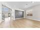 Bright, open living room with wood floors, high ceilings, and a stylish accent wall at 9916 Dusty Winds Ave, Las Vegas, NV 89117