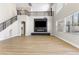 Spacious living room features a fireplace, high ceilings, modern staircase, and natural light from large windows at 9916 Dusty Winds Ave, Las Vegas, NV 89117