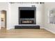 Living room with wood floors, fireplace, a large window and access to other rooms at 9916 Dusty Winds Ave, Las Vegas, NV 89117