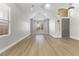 Bright, airy living room featuring wood floors, large windows, and a high vaulted ceiling at 9916 Dusty Winds Ave, Las Vegas, NV 89117