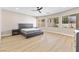 Spacious main bedroom with wood-style flooring, plenty of natural light, and neutral walls at 9916 Dusty Winds Ave, Las Vegas, NV 89117