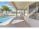 Back patio with view of pool and landscaping from under a covered patio at 9916 Dusty Winds Ave, Las Vegas, NV 89117