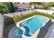 Backyard pool with spa, surrounded by lush greenery and privacy fencing, perfect for outdoor enjoyment at 9916 Dusty Winds Ave, Las Vegas, NV 89117
