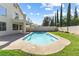 Sparkling pool surrounded by lush green grass and a concrete patio in a private backyard at 9916 Dusty Winds Ave, Las Vegas, NV 89117