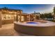 Backyard view featuring a spa, covered patio, and manicured landscaping at 6316 Bluejay Way, Las Vegas, NV 89146