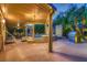 Luxurious outdoor living with a covered patio, hot tub, built-in grill, and lush landscaping at 6316 Bluejay Way, Las Vegas, NV 89146