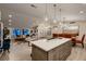 Open concept kitchen showcases an island, dining area, and inviting living space at 6316 Bluejay Way, Las Vegas, NV 89146