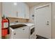Well-organized laundry room featuring modern appliances and storage cabinets at 6316 Bluejay Way, Las Vegas, NV 89146