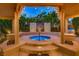 Inviting outdoor spa area surrounded by lush landscaping and ambient lighting at 6316 Bluejay Way, Las Vegas, NV 89146