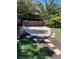 Landscaped backyard featuring a cozy, stone-walled seating area perfect for entertaining at 10381 Walking View Ct, Las Vegas, NV 89135