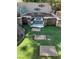 Landscaped backyard featuring a custom-built stone fire pit and well-manicured lawn at 10381 Walking View Ct, Las Vegas, NV 89135